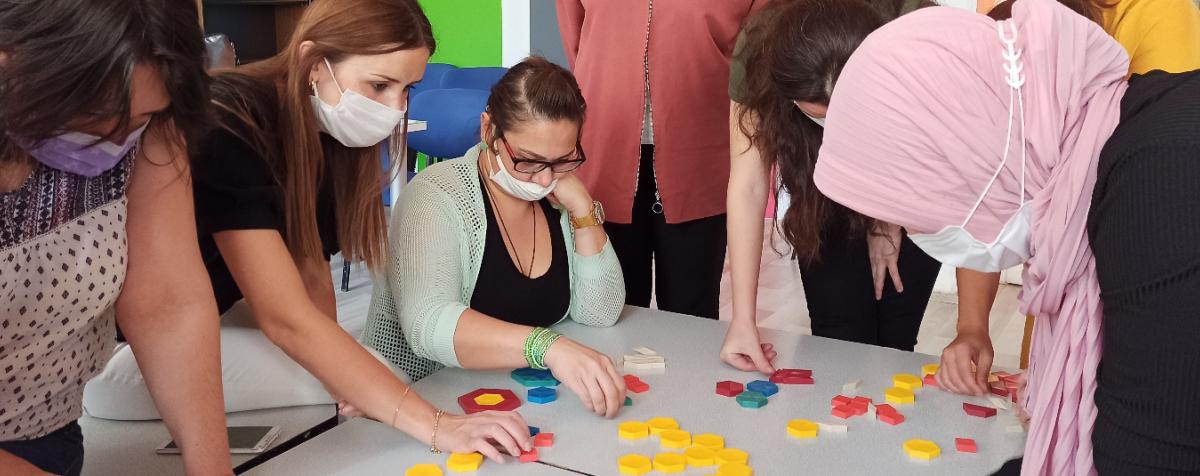 adults playing with pattern blocks